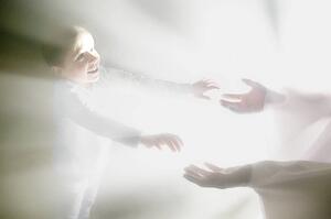 Boy reaches out for Jesus' hands