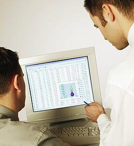 Two men working on computer