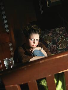 Woman sits alone