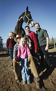 Family poses with a horse