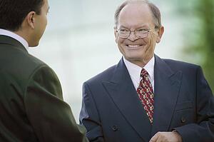 Two businessmen talk