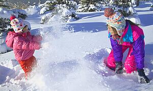Mother and Daughter having a snowball fight