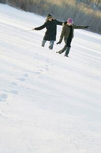 Couple play in the snow