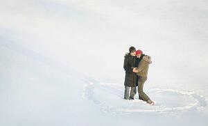 Couple stand in a heart