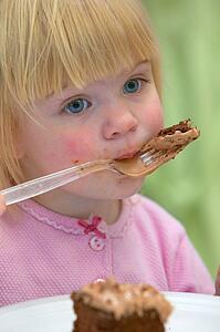 Little girl eating Birthday cake