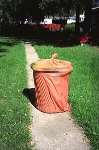 A garbage can in a garbage bag