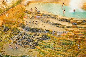 People swimming in a natural hot spring
