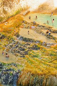 People swimming in a natural hot spring