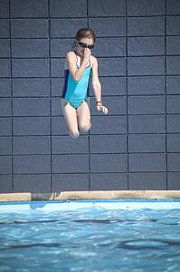 Girl jumps into the pool