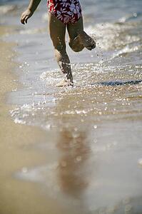 A child runs on the beach