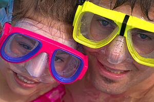 Portrait of father and daughter snorkeling