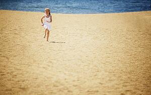 Girl runs on the beach