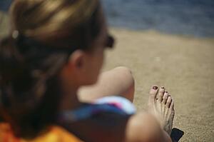 Woman sits on a beach