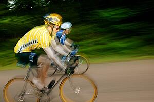 Two cyclists racing on bikes