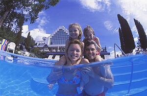 Happy family time in swimming pool