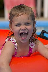 Portrait of little girl playing in Swimming Pool