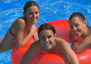 Portrait of three young women in swimming pool