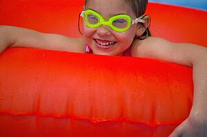Portrait of little girl playing in Swimming Pool
