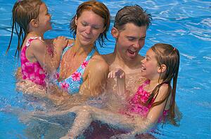 Family having fun in swimming pool