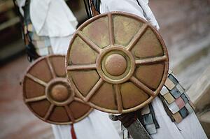 Men hold shields