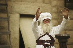 Priest with arms outstretched