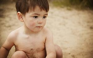 Little boy sitting on beach