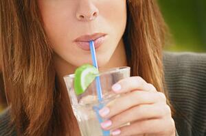 Woman sipping cold drink