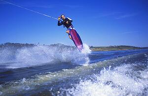 Man wakeboarding on Coal Lake Alberta Canada