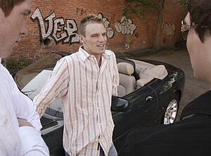 A conversation by a sports car