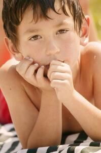 Portrait of a boy drying off in the sun