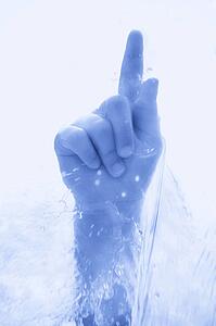 A hand piercing the cold water