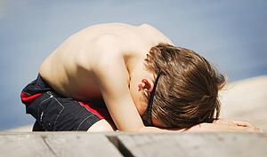 Child lays on the beach