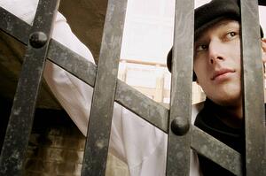 A blank stare from behind a gate