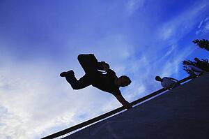 A skateboarder does a trick
