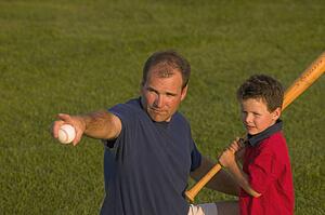 Father and son play baseball