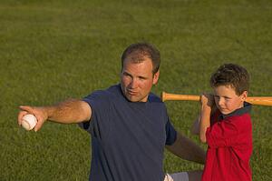 Father and son play baseball