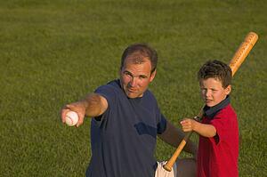 Father and son play baseball