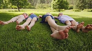 Children laying on the grass