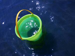 A sand bucket in the water