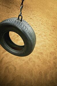 A tire swing in a playground