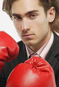 A businessman with boxing gloves