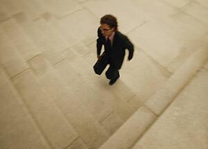 A businessman walks quickly
