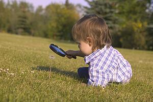 Young boy with magnifying glass