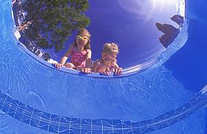 Children peering into a pool