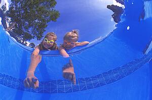 Girls pointing into pool