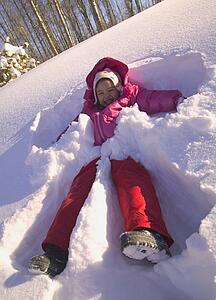 Girl making a snow angel