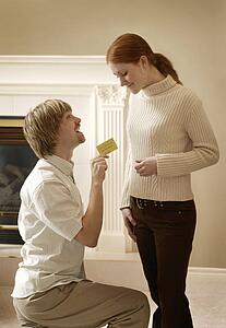 Man proposing to Woman with card