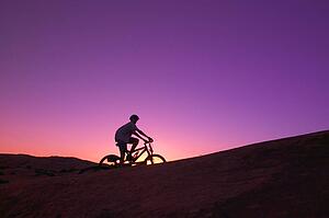 Person on bike at sunset