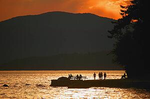 Scenic silhouette of people by water