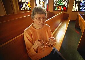 Woman holding rosary beads
